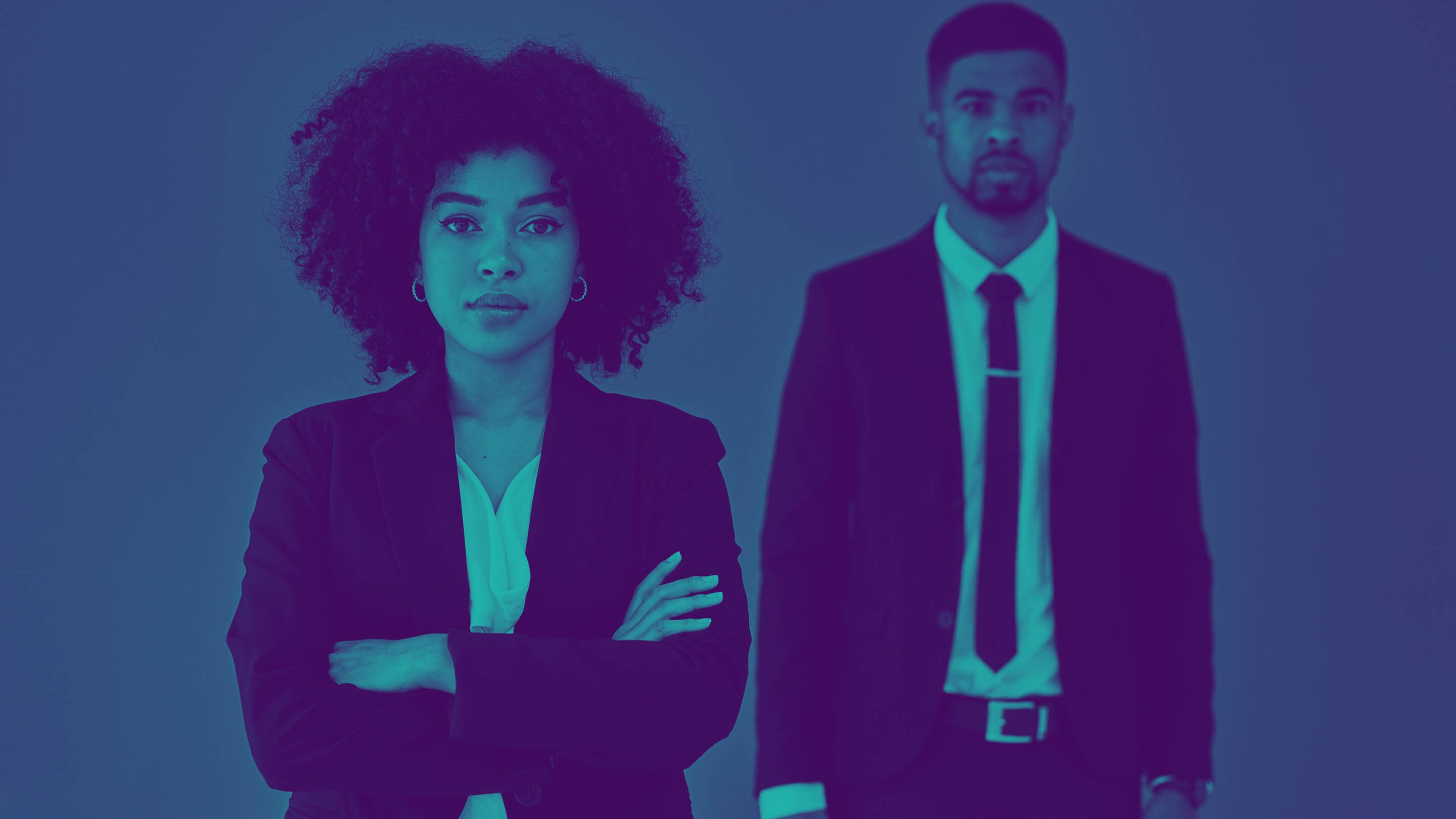 Portrait of black business woman and black business man standing with arms crossed.